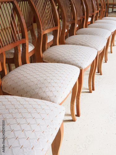 Chairs with soft seats are in a row.