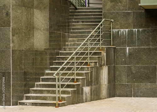 Fototapeta Naklejka Na Ścianę i Meble -  Steps and walls made of marble slabs with metal handle made of pipes