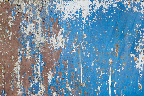 Blue texture painted metal wall with old flaking paint.