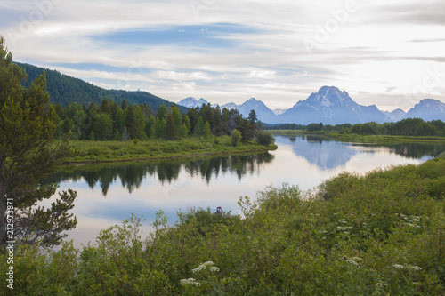 Reflection of the Grand Tetons in the Snake River viewing from Oxbow bend at Grand Teton National Park at sunset