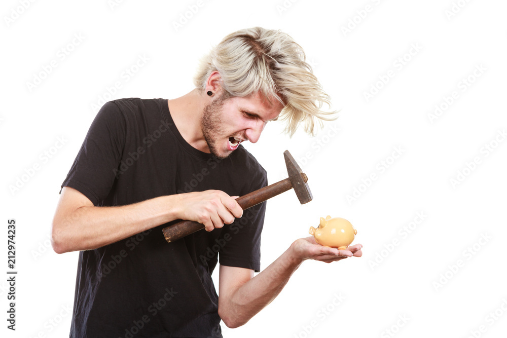 Sreaming man trying break piggy bank with hammer Sreaming man trying break piggy bank with hammer