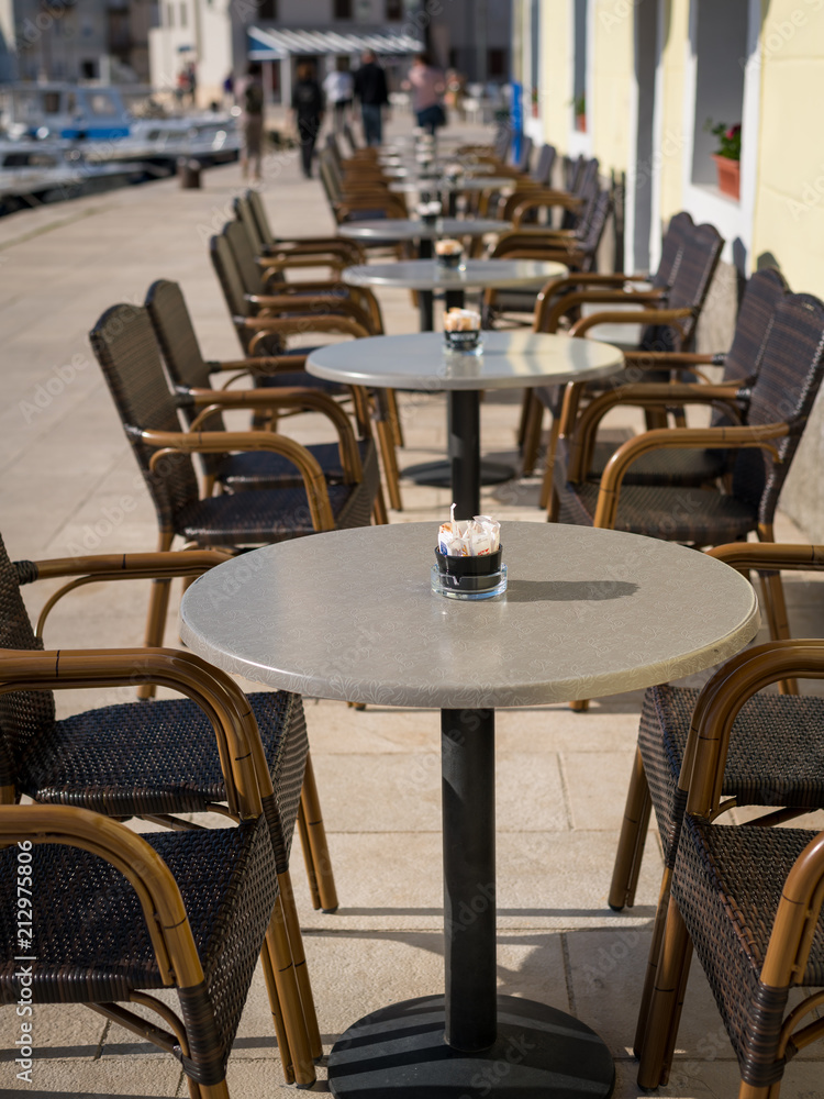 Empty tables and chairs of a cafe in Cres