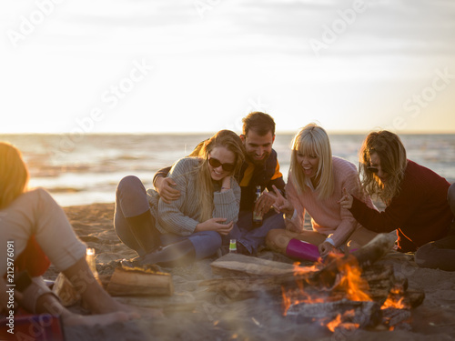 Friends having fun at beach on autumn day © .shock