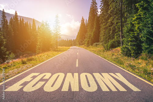 Economy word written on road in the mountains