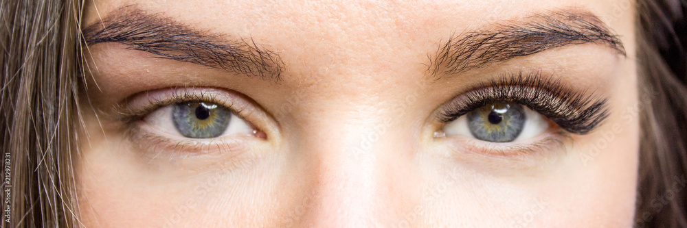 Obraz premium Eyelash Extension Procedure. Before and after. Woman Eyes with Long false Eyelashes. Close up macro shot - Beauty and fashion concept