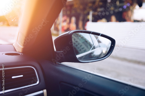 Fototapeta Naklejka Na Ścianę i Meble -  Shoot in side-view mirror of car. View from a side mirror of a car while cruising on a highway