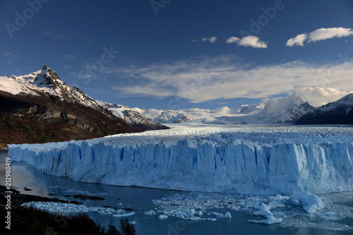 Glacier with blue sky and snowy mountain