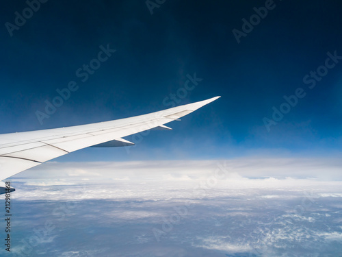 View from airplane window with blue sky and white clouds, background for travel holiday trip, Aircraft on the sky.