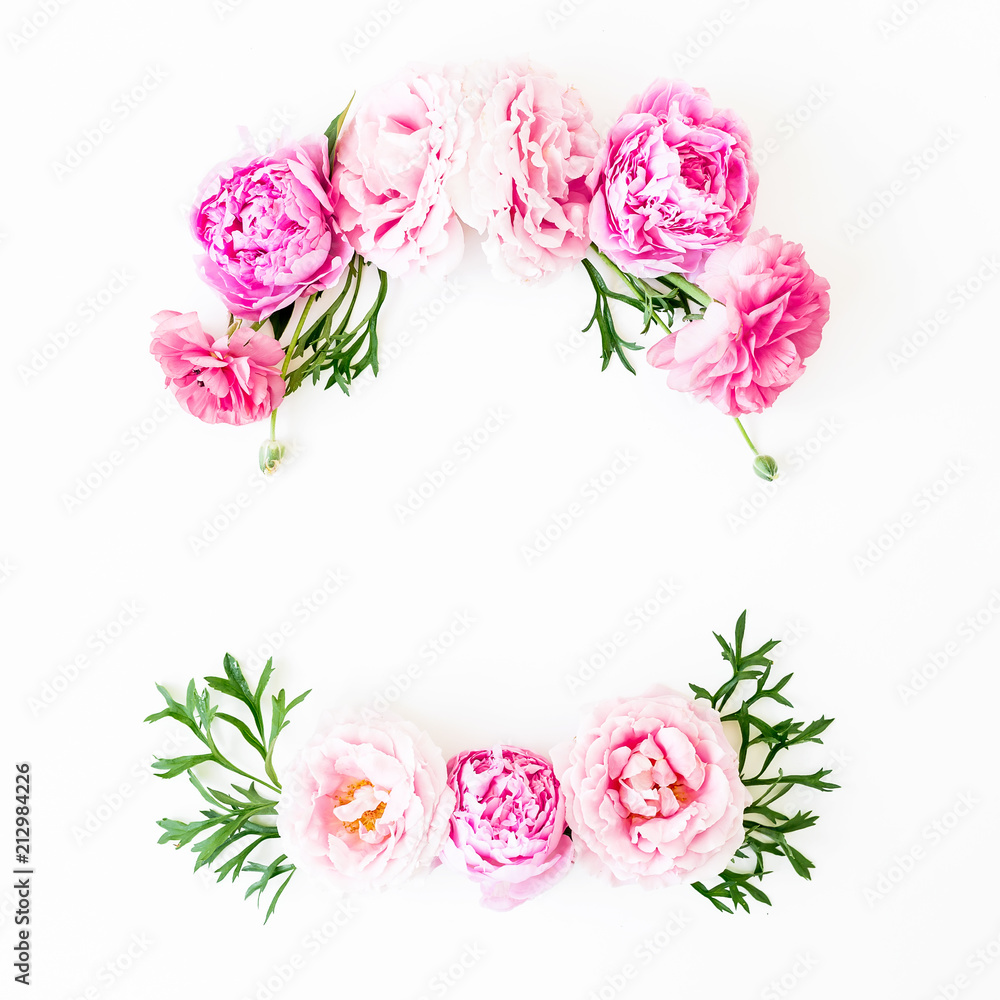 Floral frame made of rink roses and green leaves on white background. Flat lay, top view. Flower background