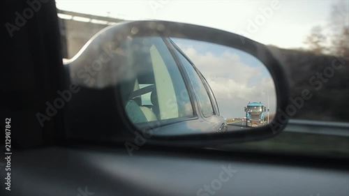 Passing a truck, viewed through the wing mirror. photo