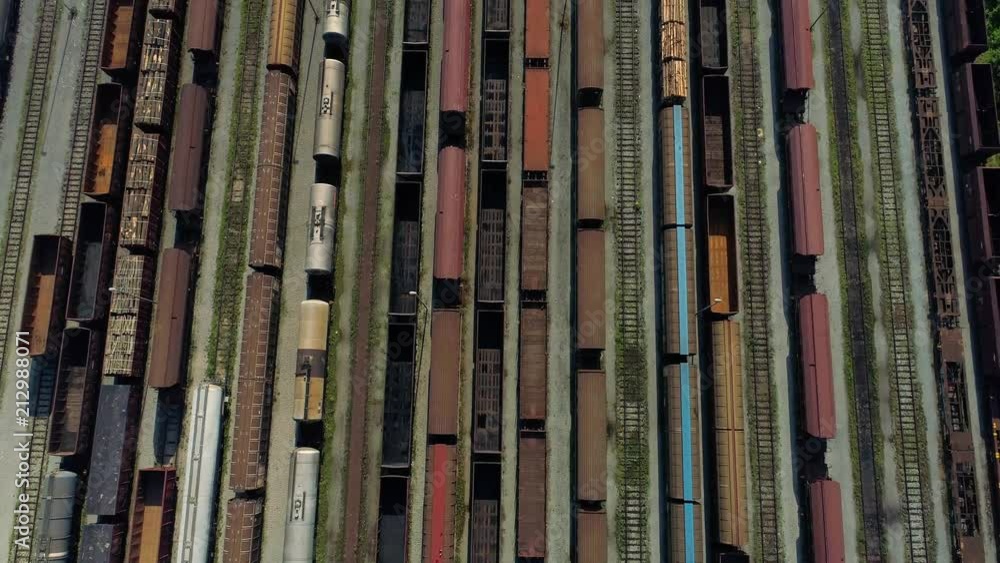 4k aerial shot of a rail yard - tilt up reveal of a city 4k aerial shot of a rail yard - tilt up reveal of a city