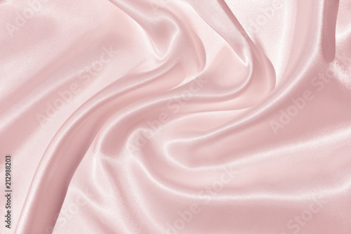 The texture of the satin fabric of pink color for the background 