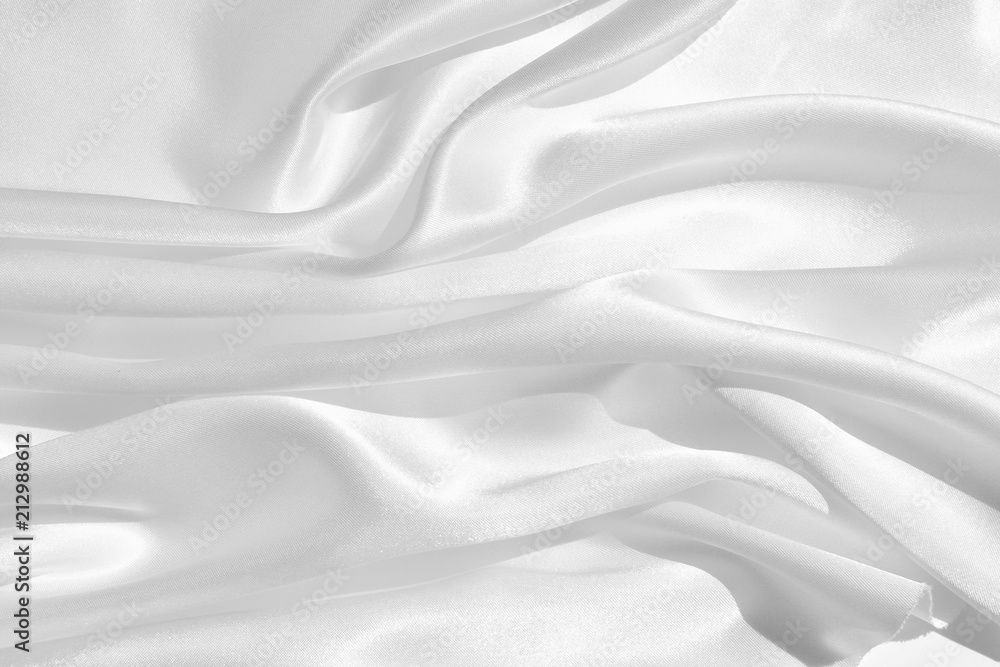 Fototapeta premium The texture of the satin fabric of white color for the background 