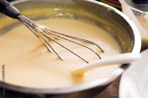 Mixing batter or dough for pancake or making desserts.Close up ,soft focus.