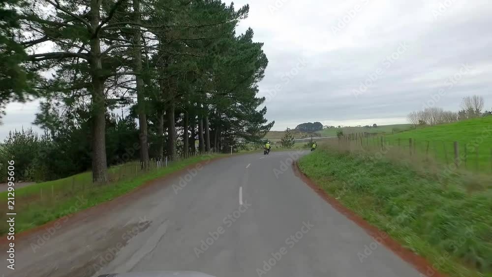 Motor bike training on open roads. Shot from following car. Motor bike training on open roads. Shot from following car.