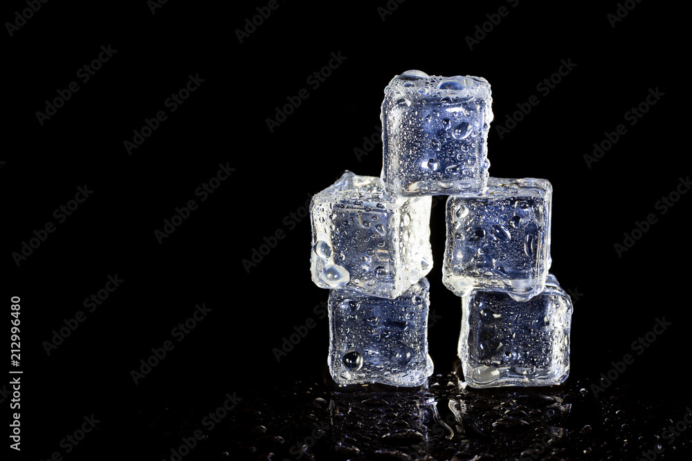 ice cubes reflection on black table background. ice cubes reflection on black table background.