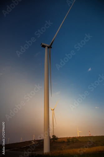 Wind turbine farm of silhouette at sunset.