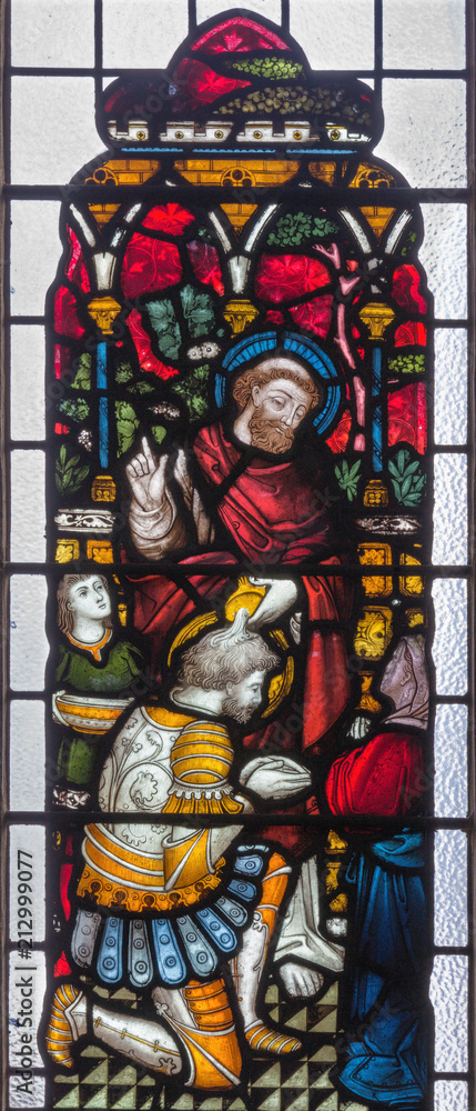 LONDON, GREAT BRITAIN - SEPTEMBER 19, 2017: Peter Baptizing the Centurion Cornelius on the stained glass in St Mary Abbot's church on Kensington High Street.