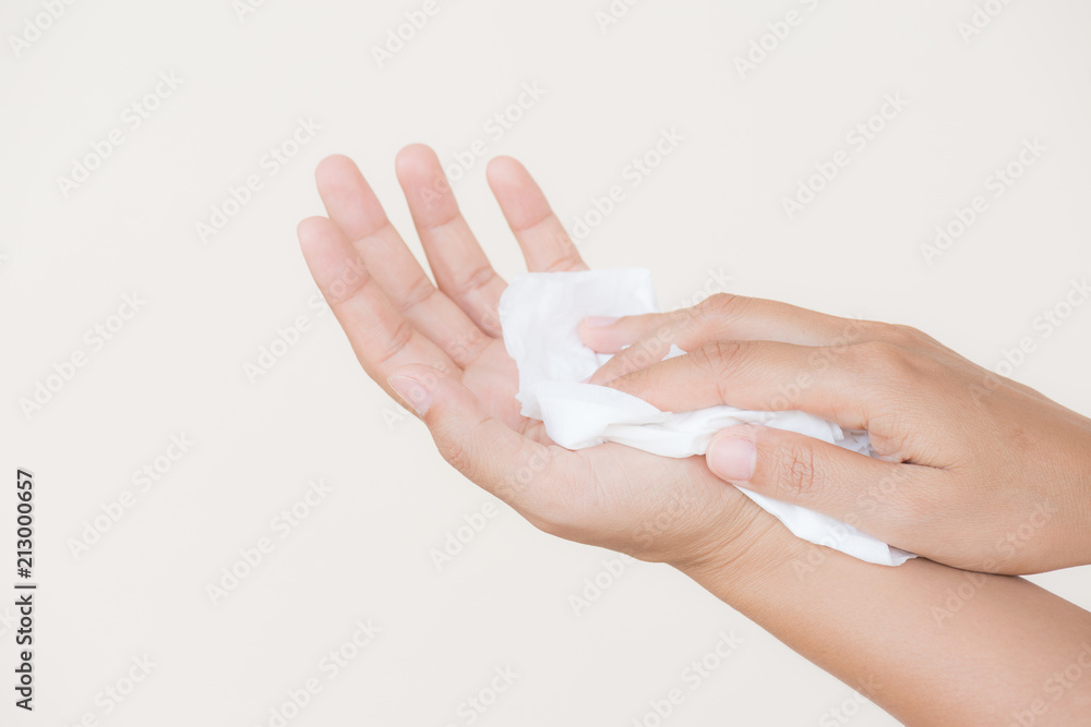Woman cleaning her hands with a tissue. Healthcare and medical concept. Woman cleaning her hands with a tissue. Healthcare and medical concept.