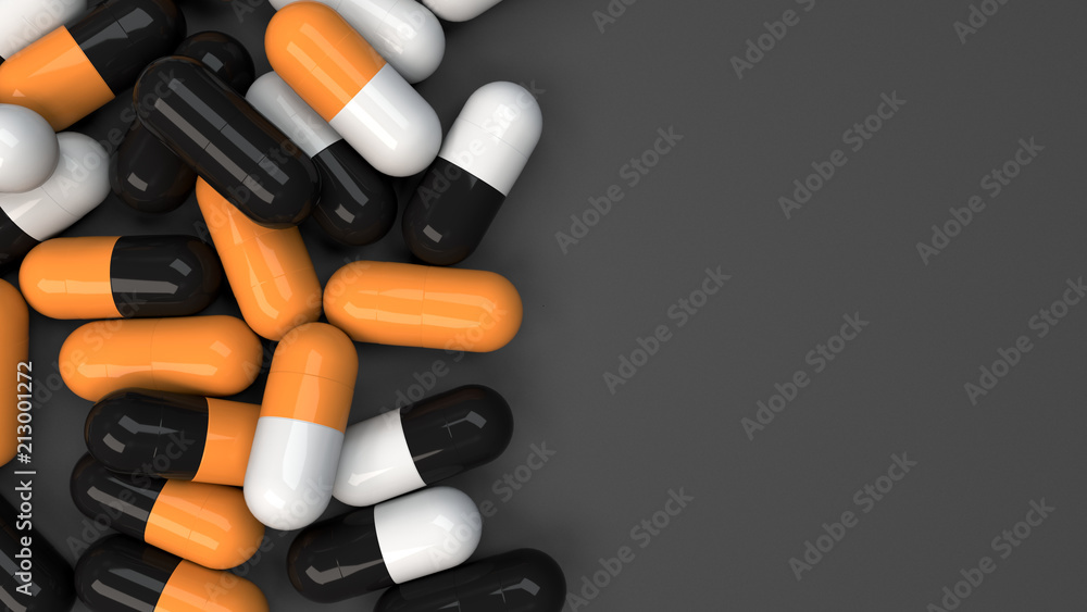Pile of black, white and orange medicine capsules