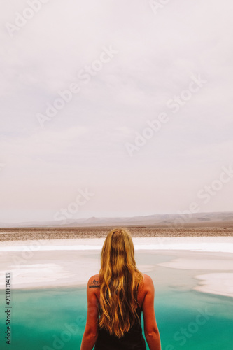 Chile. San Pedro de Atacama. Lagunas Escondidas de Baltinache The girl stands with her back to the salt lake in the desert © Margarita Timofeeva
