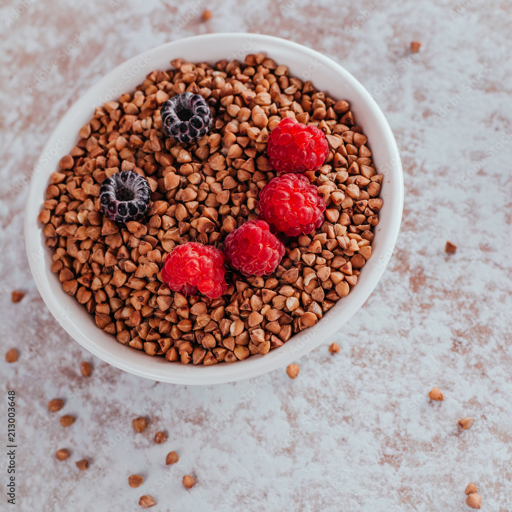 Smile from blackberries and raspberries in a plate with buckwheat and rolls. Smile from blackberries and raspberries in a plate with buckwheat and rolls.
