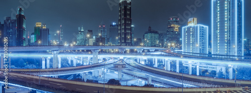 Photography aerial view of buildings and highway interchange at night in Shanghai city