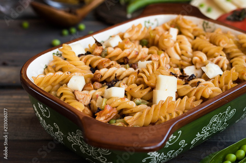 Fusilli pasta with zucchini, goat cheese and green peas