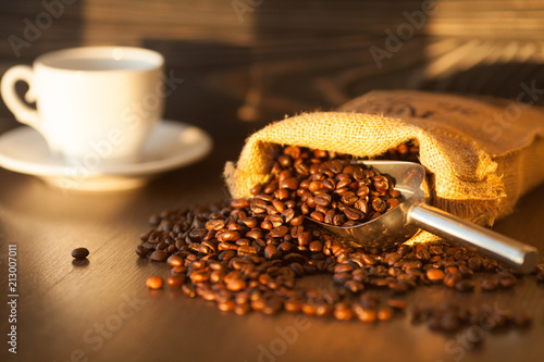 Bag with coffee beans on wooden background. Coffee concept. Fresh beans.