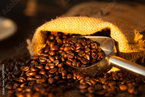 Bag with coffee beans on wooden background. Coffee concept. Fresh beans.