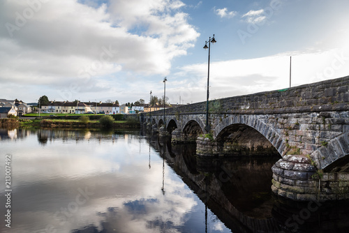 Beautiful bridge and reflections on river at morning photo