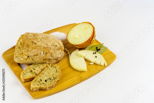 Fototapeta Naklejka Na Ścianę i Meble -  Bread, onion, salt, pepper and bay leaves on a wooden board.