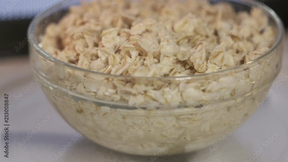 Bowl of oatmeal rotating inside microwave. Warming up food inside microwave oven. Bowl of oatmeal rotating inside microwave. Warming up food inside microwave oven.
