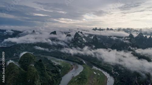 aerial view of cloudscape above farmland and mountain around the ancient town of Xingping, China