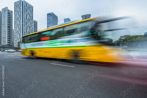 urban city road with motion bus at twilight, china.