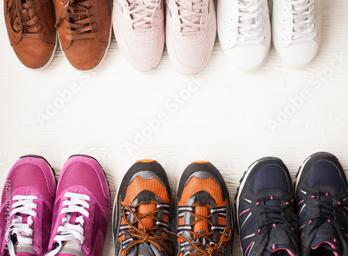 Trzy pary kolorowych butów do biegania / butów do ćwiczeń na podłodze w sklepie sportowym / obuwniczym. Potencjalne miejsce na podłodze.