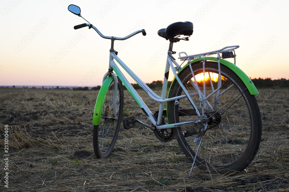 Fototapeta premium Bicycle in the stubble in a wheat field