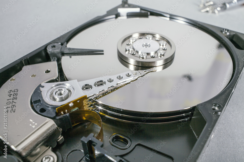 Hard disk drive platter. Open hdd hard disk. Data recovery from damaged  media. Disk head above the plates Stock-Foto | Adobe Stock