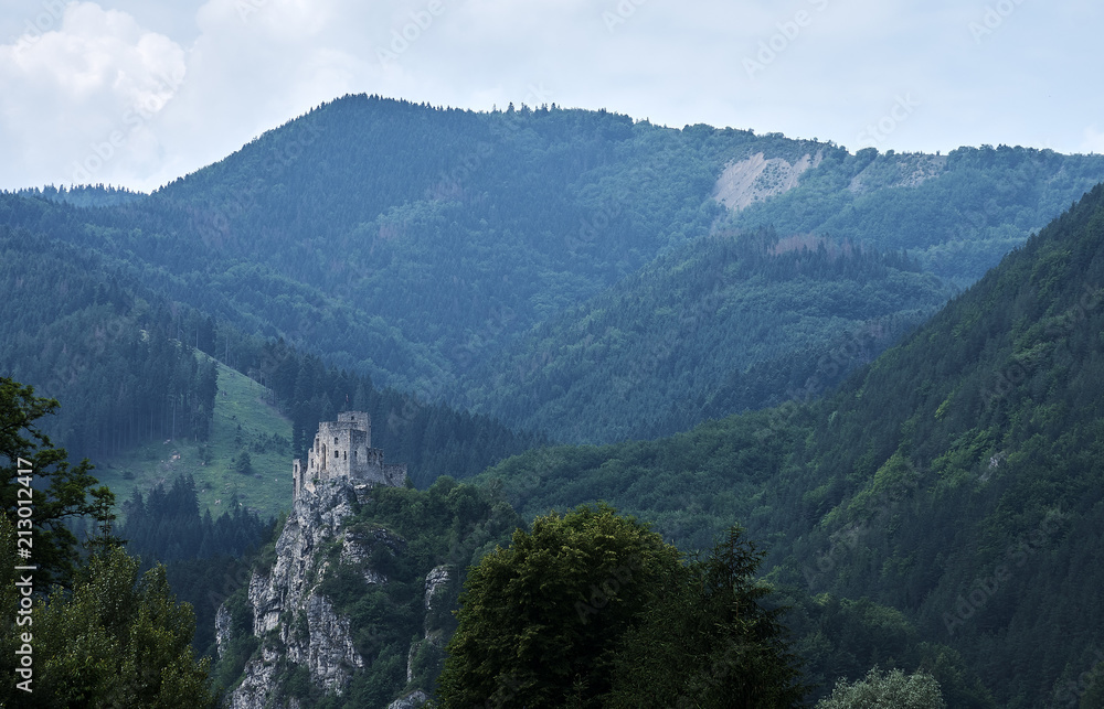 View of a mountain landscape with forest and ruins of Strecno Castle, Slovakia