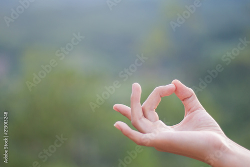 Close up of woman hand, meditating on yoga practice.
