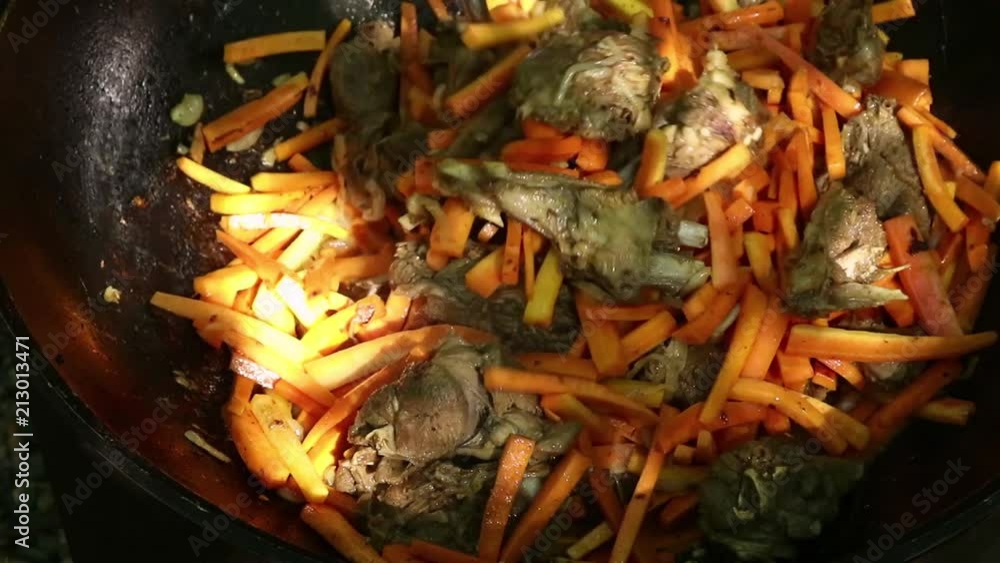 Cooking of pilaf. Grilled vegetables in a cauldron, outdoor. bbq food. camping concept Cooking of pilaf. Grilled vegetables in a cauldron, outdoor. bbq food. camping concept