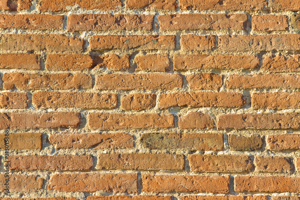 Old italian brick wall after an architectural restoration (Italy