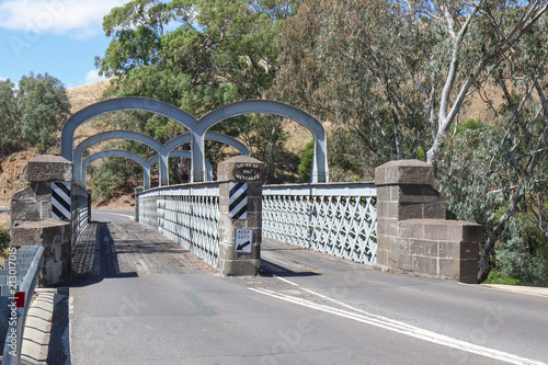 REDESDALE, AUSTRALIA - February 25, 2018: The Redesdale bridge (1867-68), over the Campaspe River is one of the oldest iron lattice-truss bridges in Victoria, Australia photo