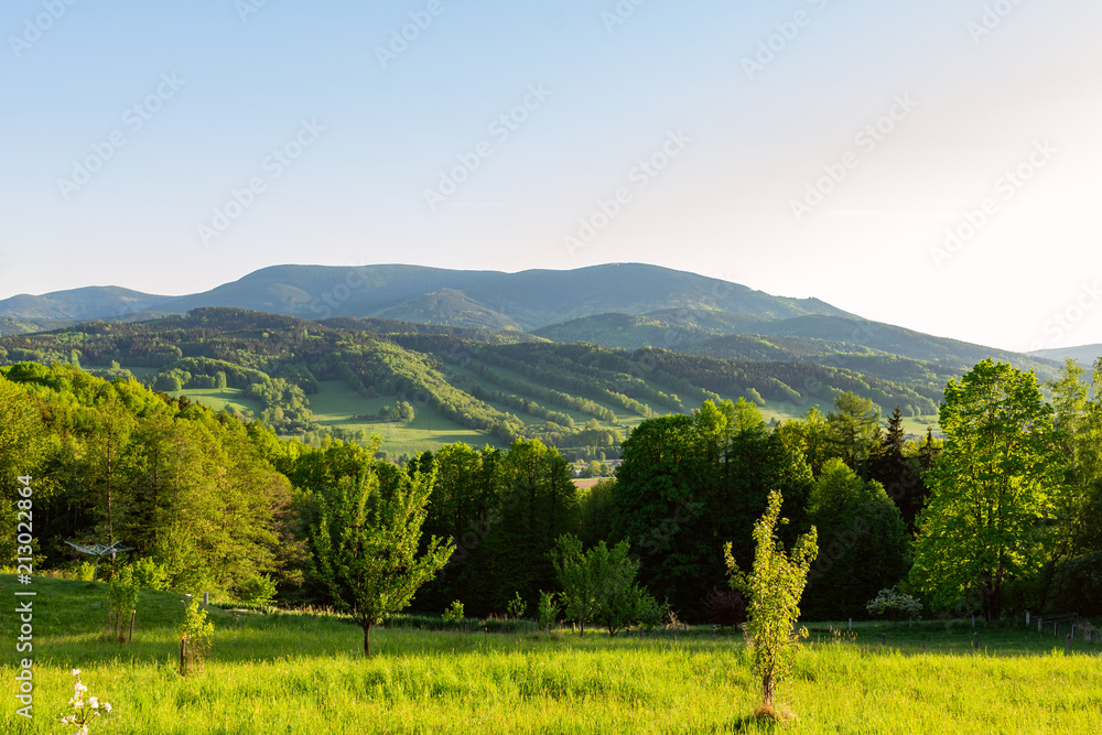 Obraz premium Majestic landscape of mountains and Meadow. Cycling mountain road. Misty mountain road in high mountains.. Cloudy sky with mount