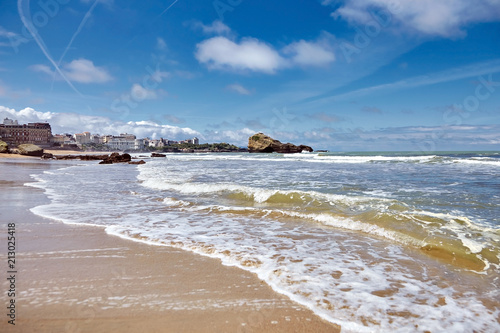 Fototapeta Naklejka Na Ścianę i Meble -  Biarritz city and its famous sand beaches - Miramar and La Grande Plage with ocean waves , Bay of Biscay, Atlantic coast, Basque country, France. Summer sunny day and blue sky with airplane trail