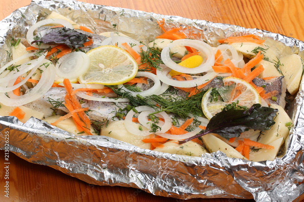 Preparation a marinated hake with potatoes for baking in the oven Preparation a marinated hake with potatoes for baking in the oven