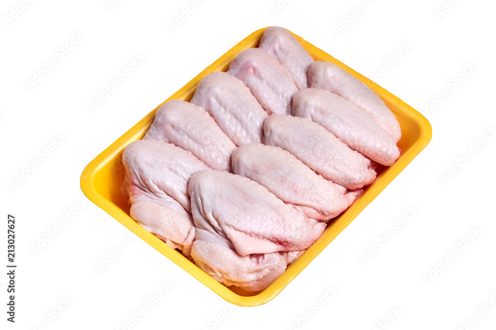 Foto Stock Raw and uncooked chicken wings in a yellow plastic container.  Meat of poultry in tray, isolated on white background. Top view | Adobe  Stock