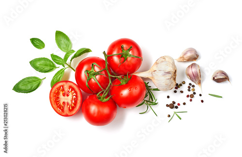 Ripe red tomatoes with basil, rosemary, garlic and pepper isolated on white background. Top view.