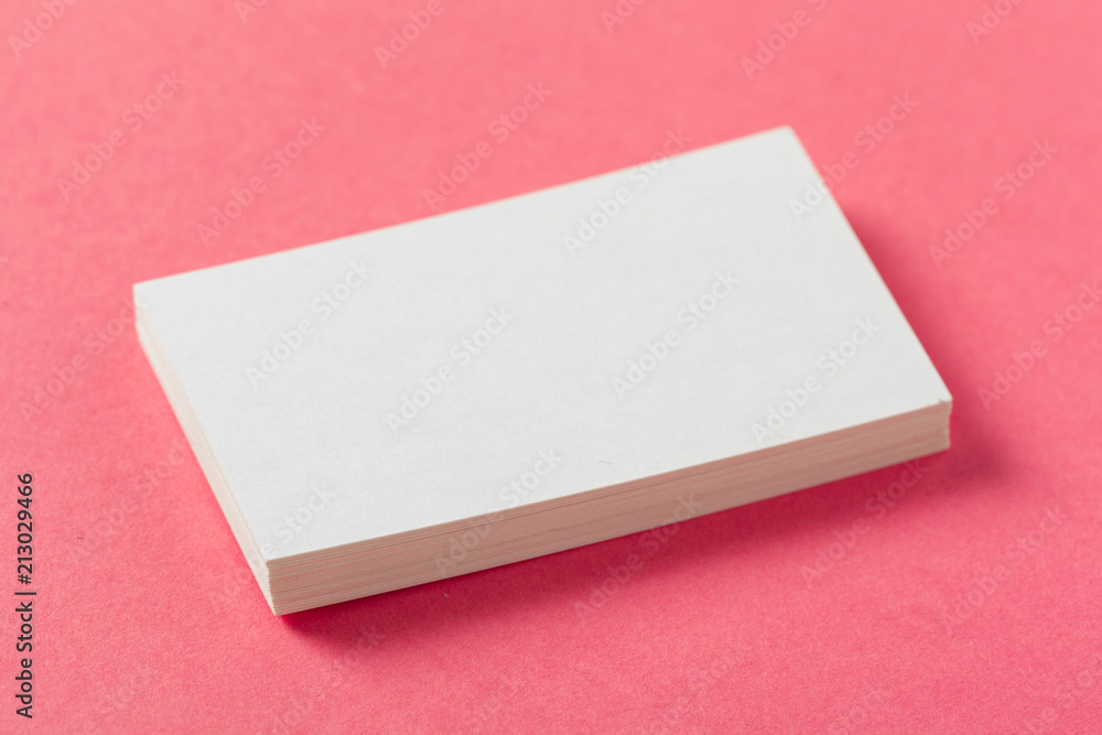 Blank paper pieces on a colored pink background Blank paper pieces on a colored pink background