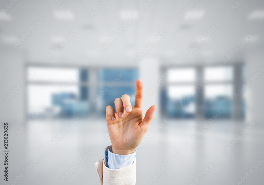 Choosing gesture of businessperson in elegant modern interior in sunshine light Choosing gesture of businessperson in elegant modern interior in sunshine light